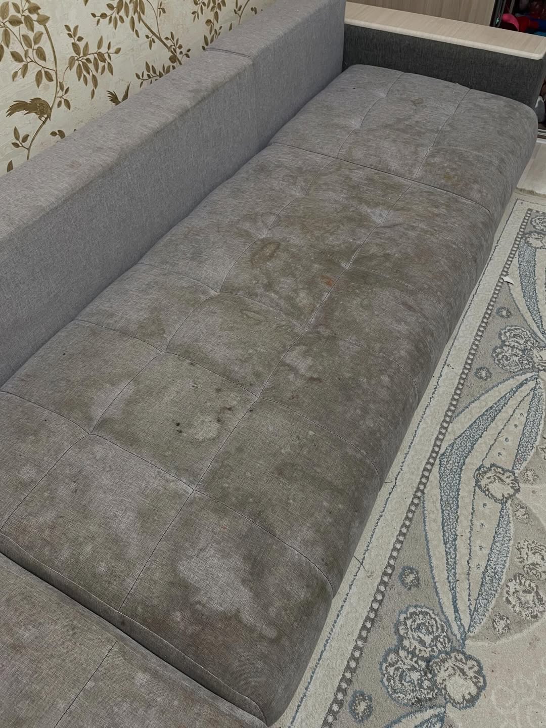 Grey sofa before cleaning